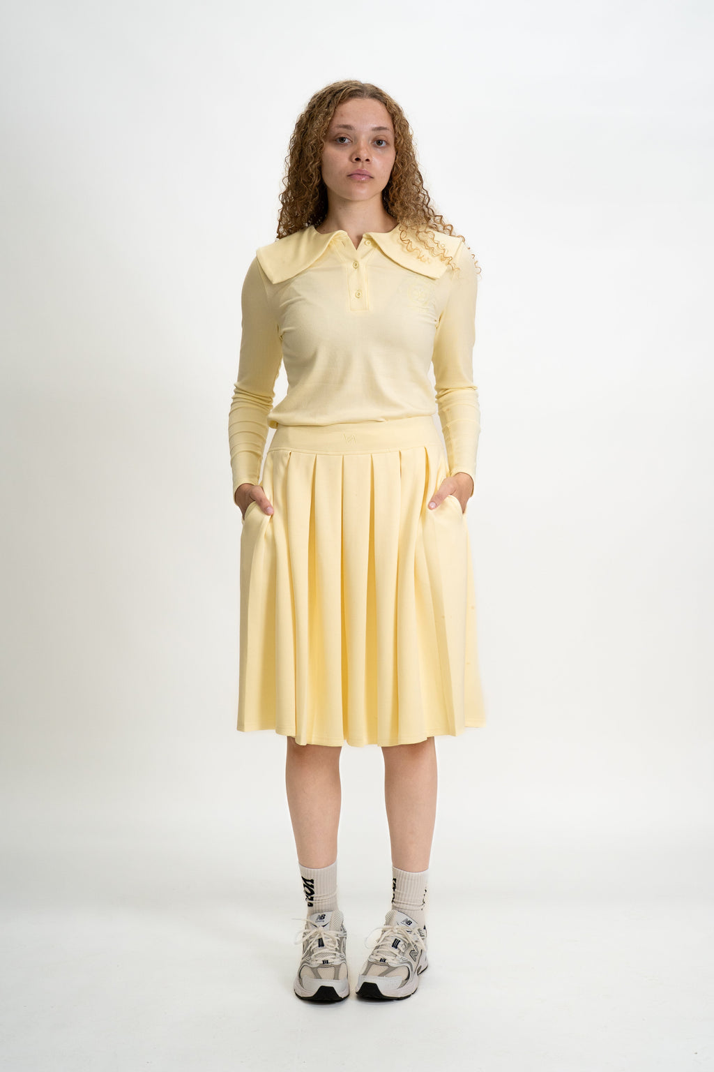 Woman wearing a yellow outfit with a white background